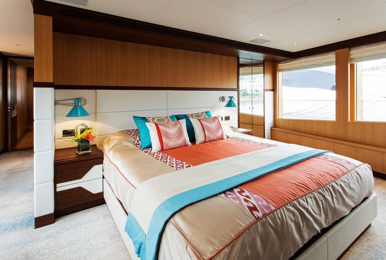 a bed with a colorful comforter aboard GRAY CLIFFS Yacht for Sale