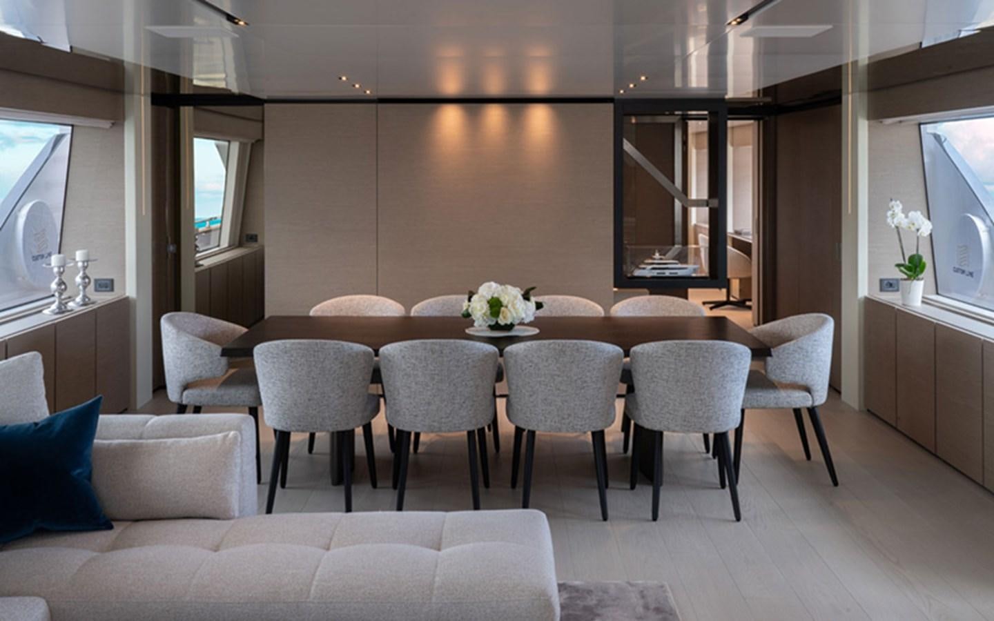 a room with a table chairs and a couch aboard ADELIA Yacht for Sale