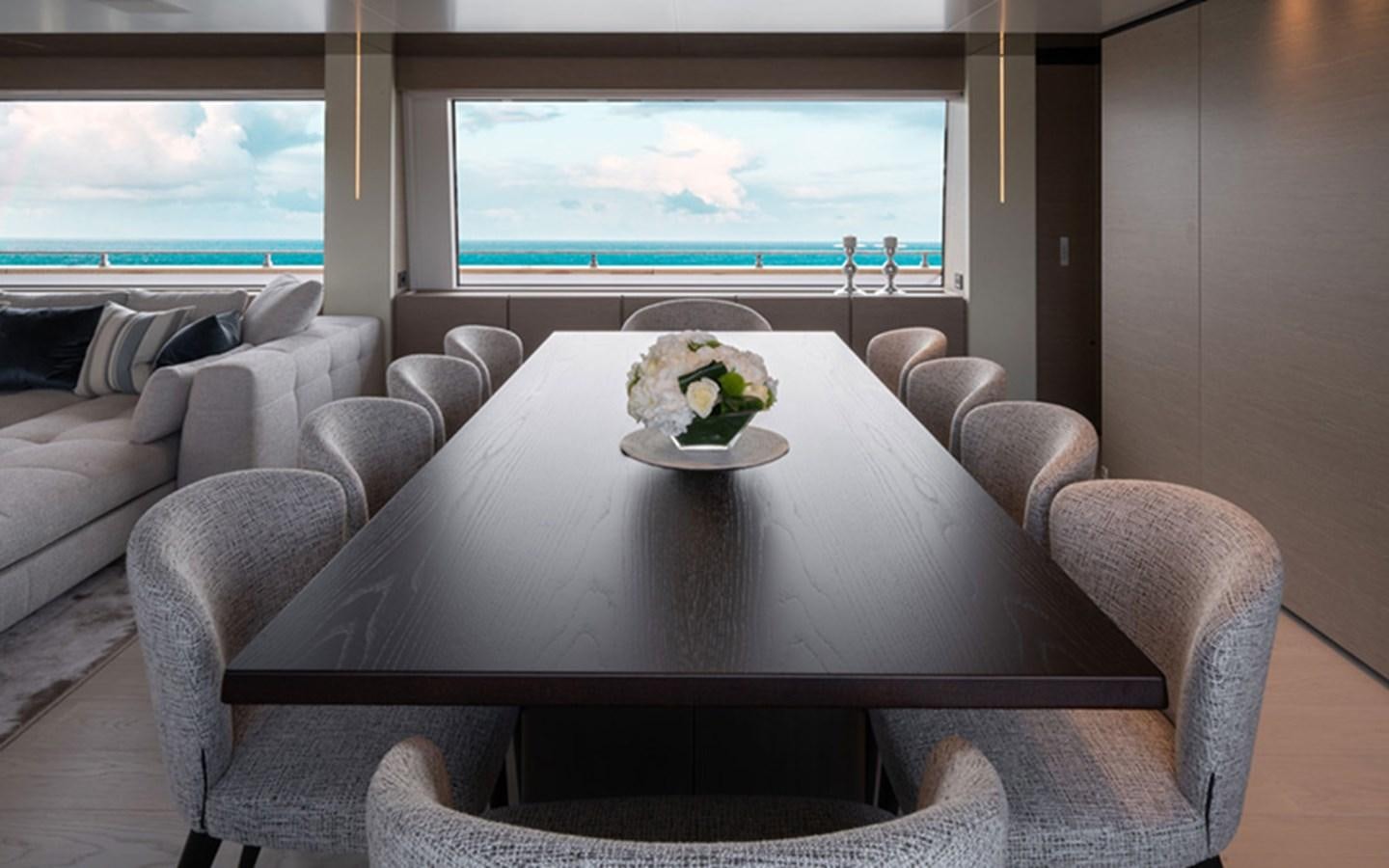 a table with flowers on it aboard ADELIA Yacht for Sale