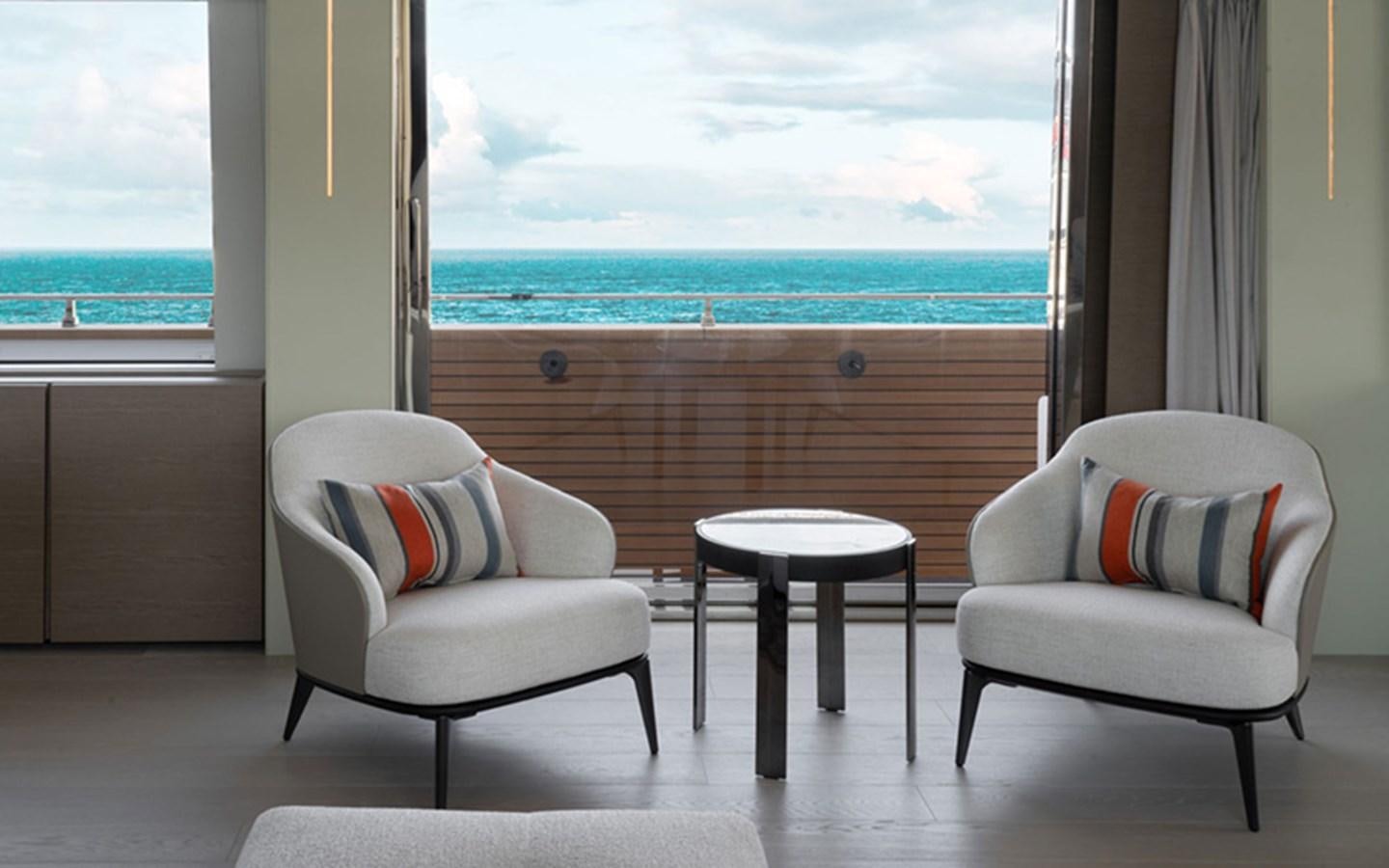 a couple of chairs in front of a window aboard ADELIA Yacht for Sale