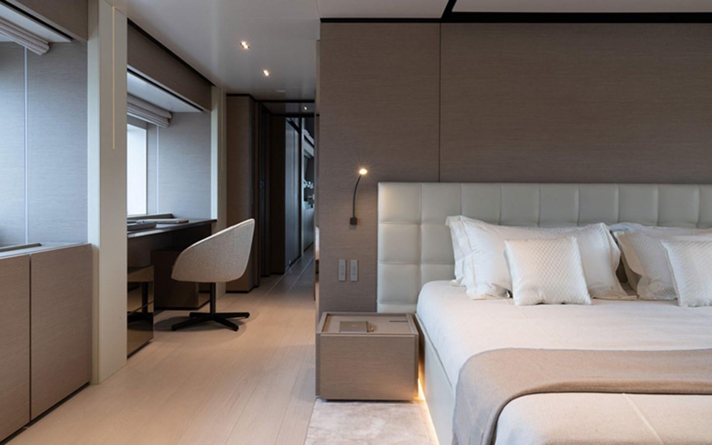 a bedroom with a bed and desk aboard ADELIA Yacht for Sale