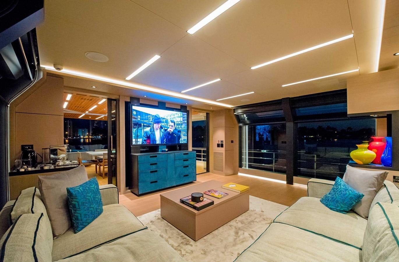 a living room with a large tv aboard CYRA Yacht for Sale