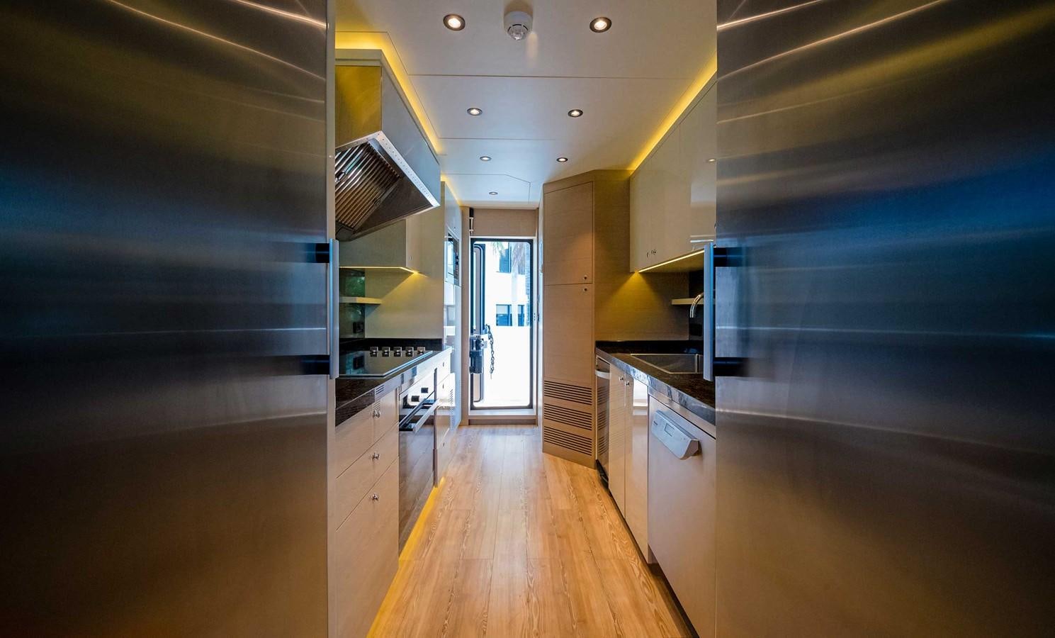 a kitchen with a wood floor aboard CYRA Yacht for Sale