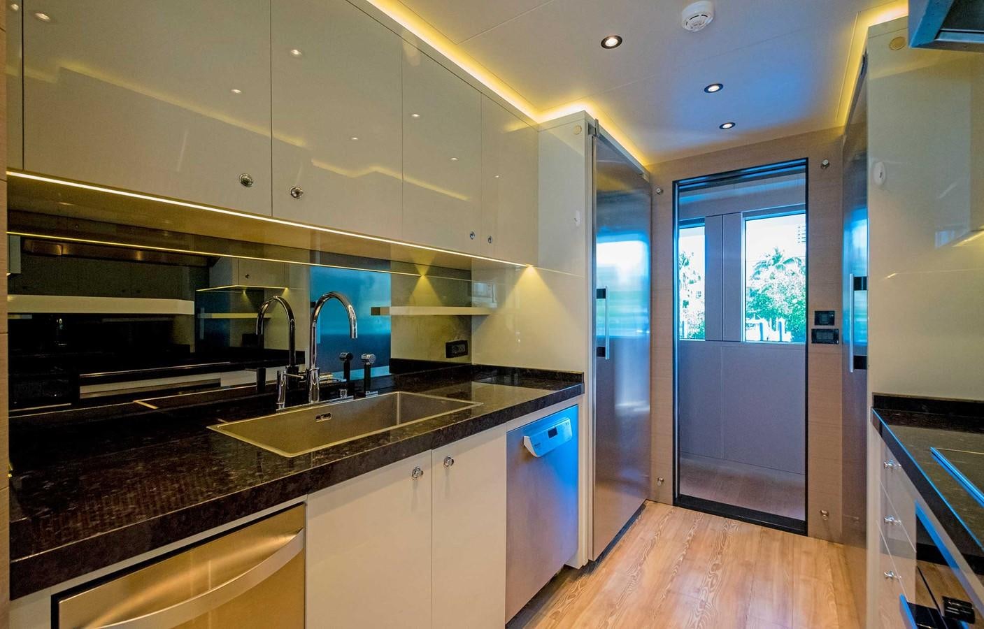 a kitchen with a sink and a large window aboard CYRA Yacht for Sale