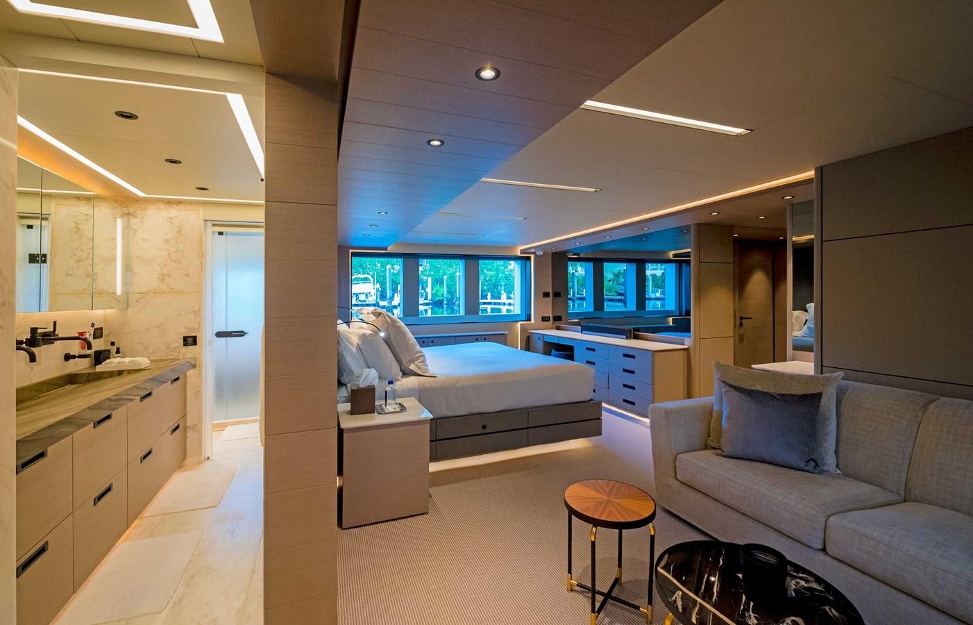 a large room with a bed and a couch aboard CYRA Yacht for Sale