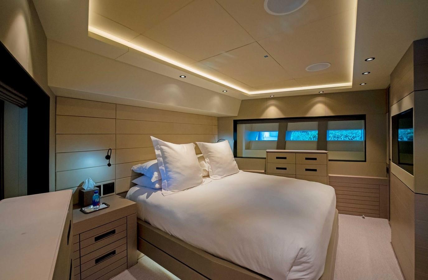 a room with a bed and a television aboard CYRA Yacht for Sale