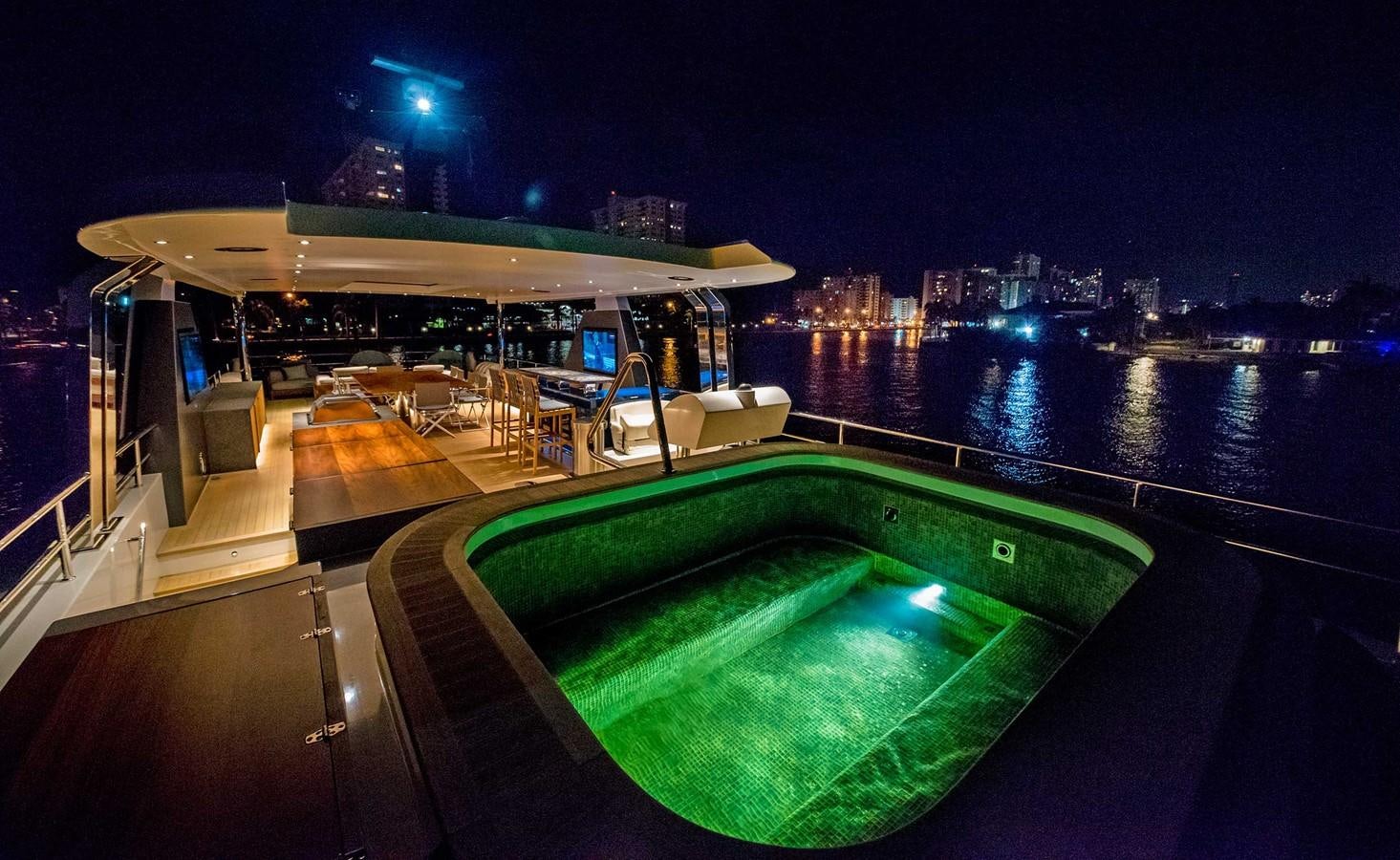 a pool on a deck at night aboard CYRA Yacht for Sale