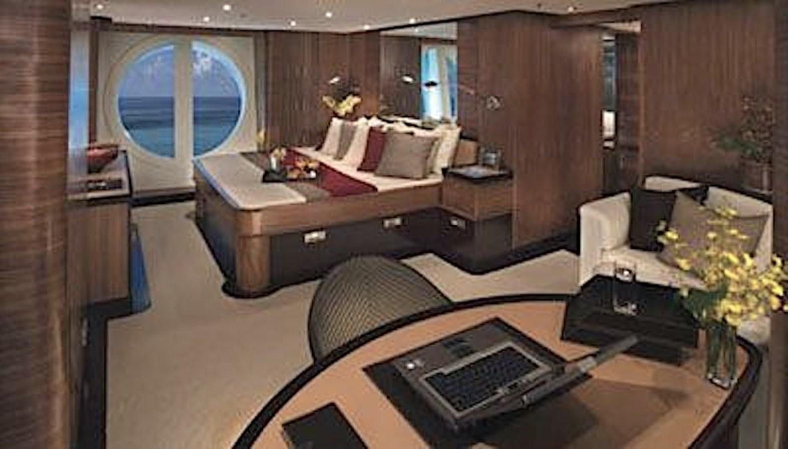 a room with a bed and a desk aboard NAZAR Yacht for Sale