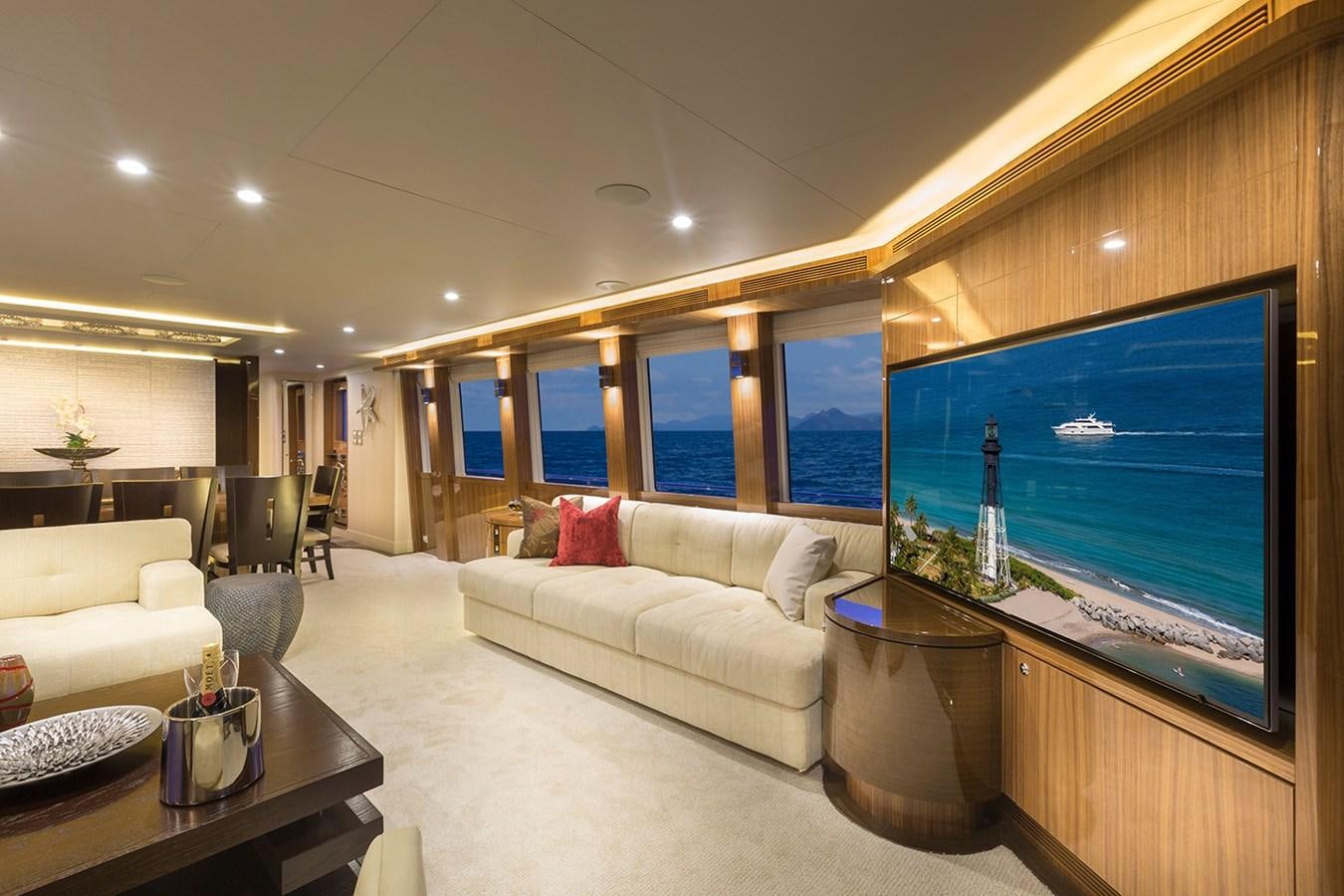 a living room with a large screen aboard OUR TRADE Yacht for Sale