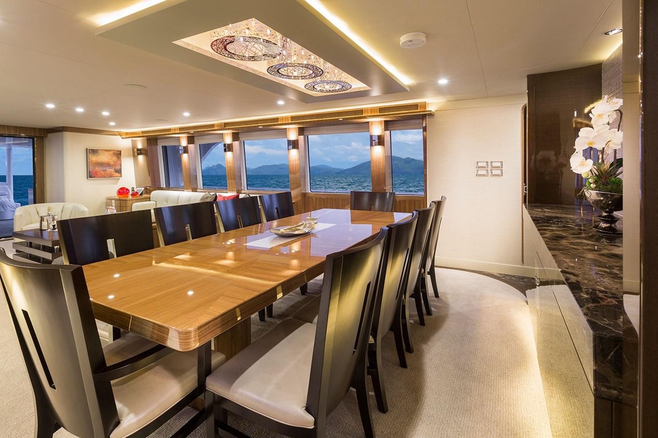 a room with tables and chairs aboard OUR TRADE Yacht for Sale