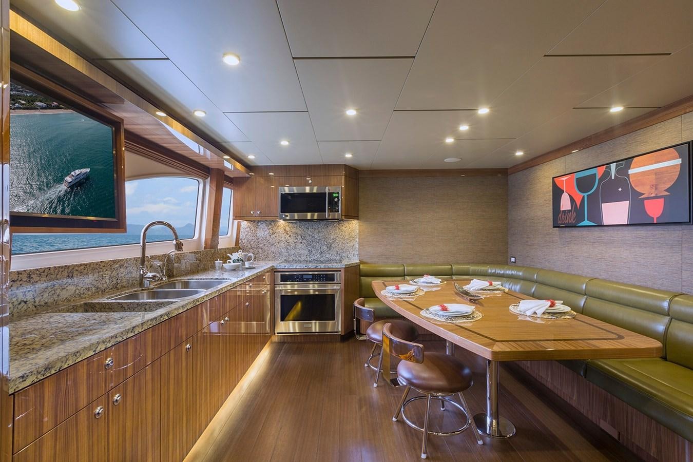 a kitchen with a table and chairs aboard OUR TRADE Yacht for Sale