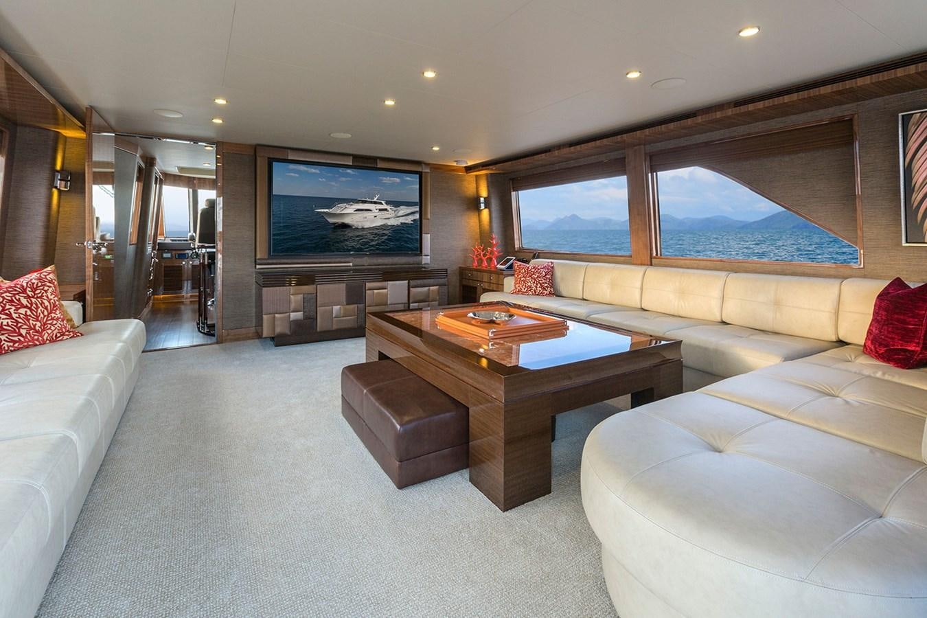 a living room with a large screen aboard OUR TRADE Yacht for Sale