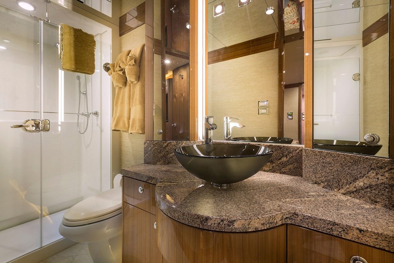 a bathroom with marble counter tops aboard OUR TRADE Yacht for Sale