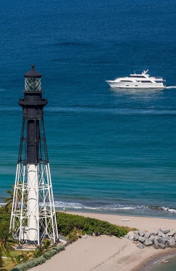 a lighthouse and a boat in the water aboard OUR TRADE Yacht for Sale