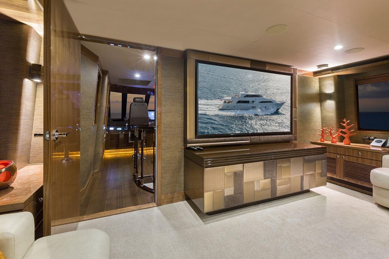 a large room with a tv and a fireplace aboard OUR TRADE Yacht for Sale