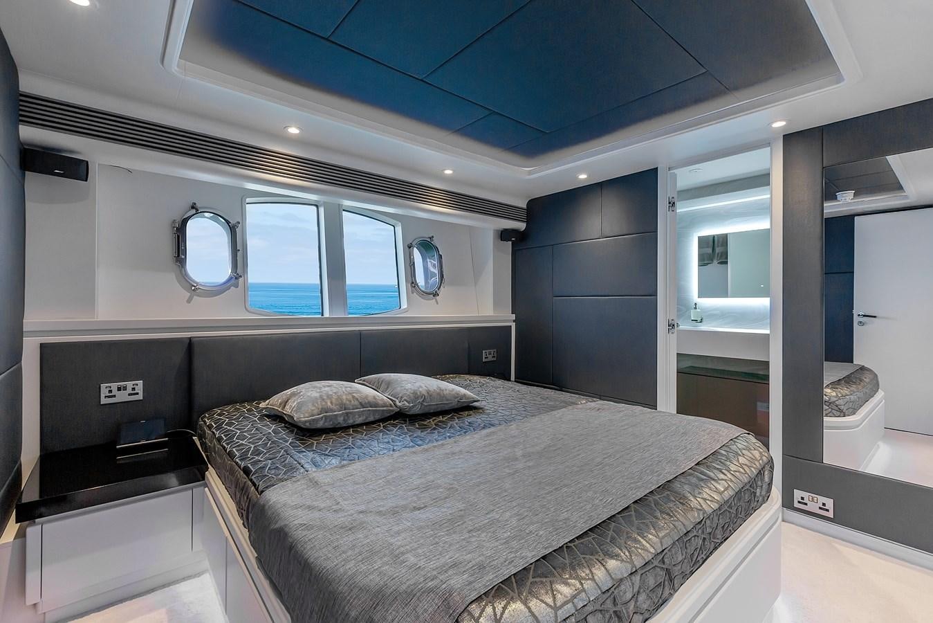 a bed in a room aboard THINK BIG Yacht for Sale