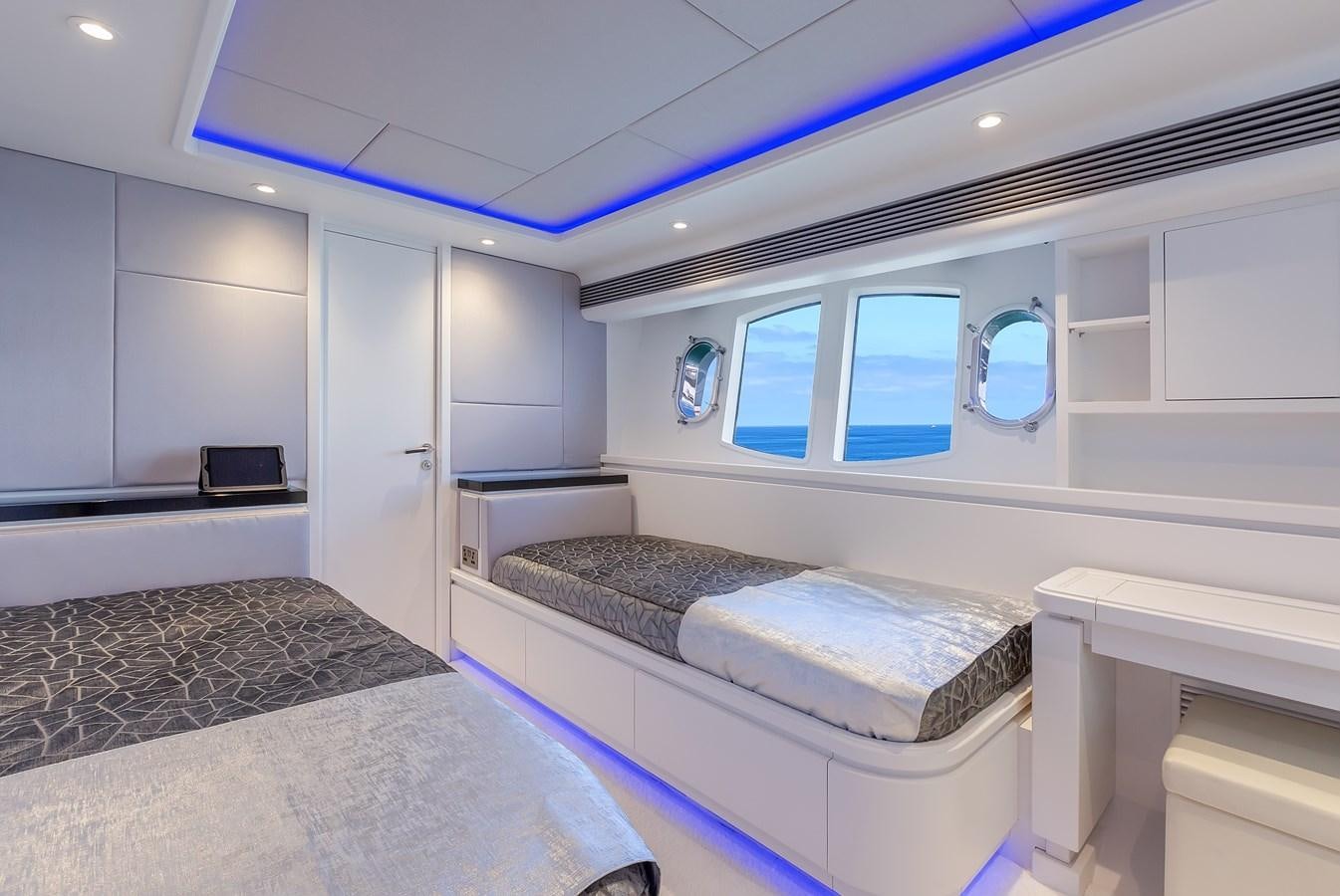 a room with a bed and a desk aboard THINK BIG Yacht for Sale