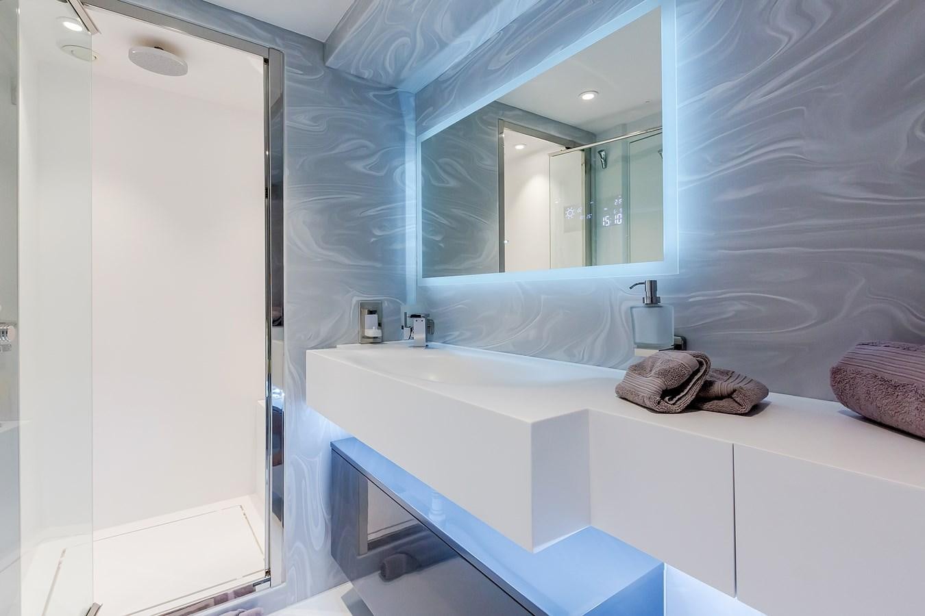 a bathroom with a large mirror aboard THINK BIG Yacht for Sale