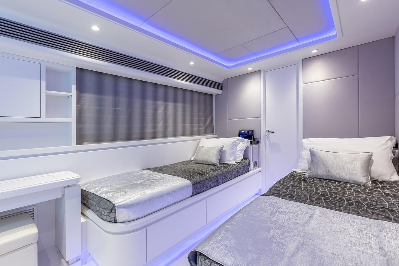 a room with two beds aboard THINK BIG Yacht for Sale