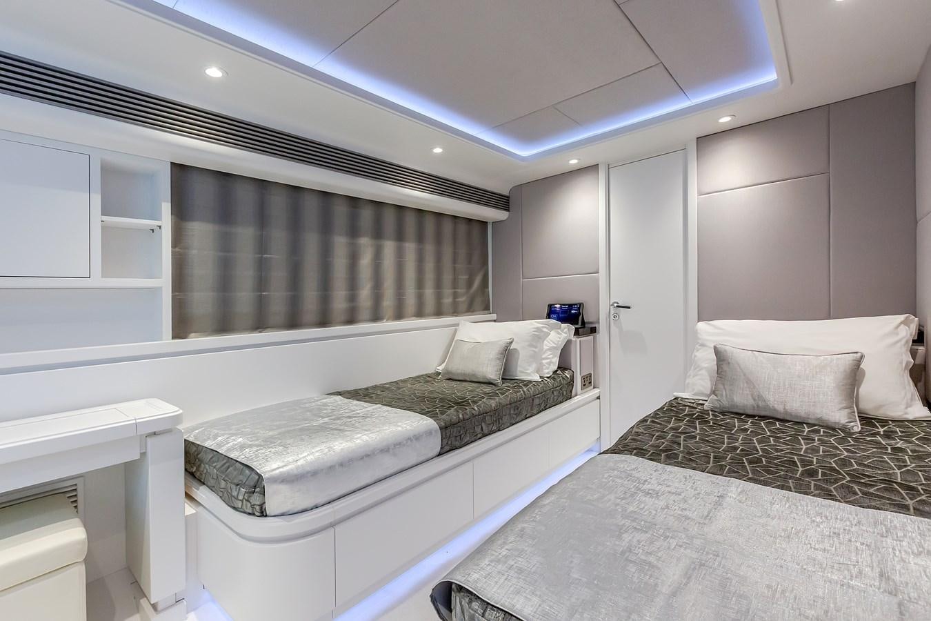 a room with two beds aboard THINK BIG Yacht for Sale