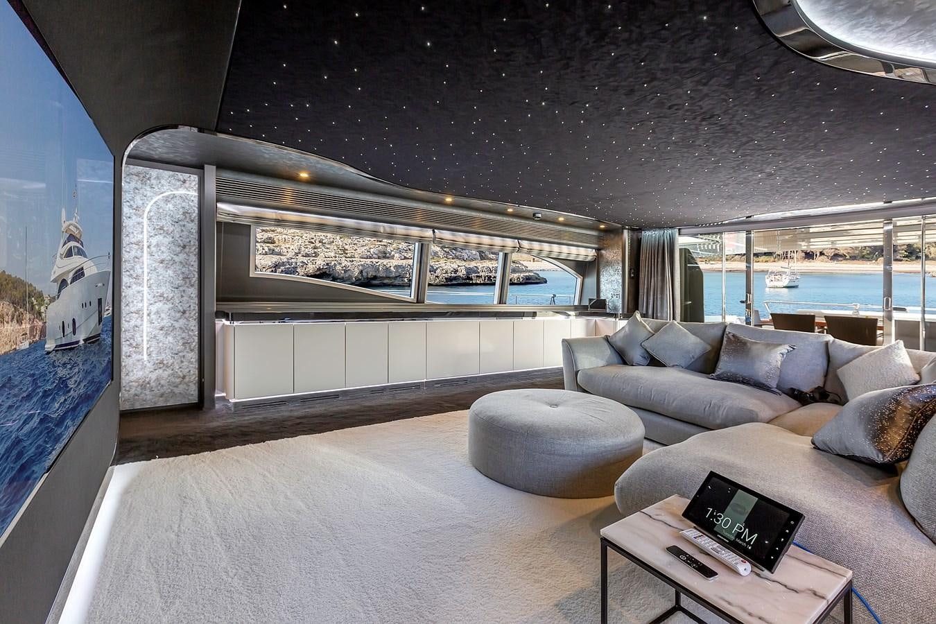 a room with a couch and a table aboard THINK BIG Yacht for Sale