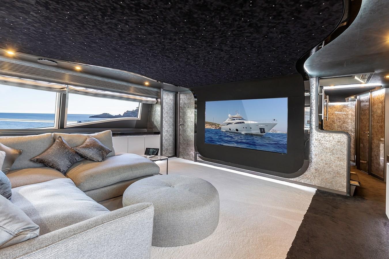 a room with a couch and a television aboard THINK BIG Yacht for Sale