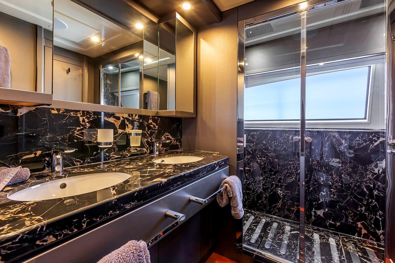 a bathroom with a large mirror aboard THINK BIG Yacht for Sale