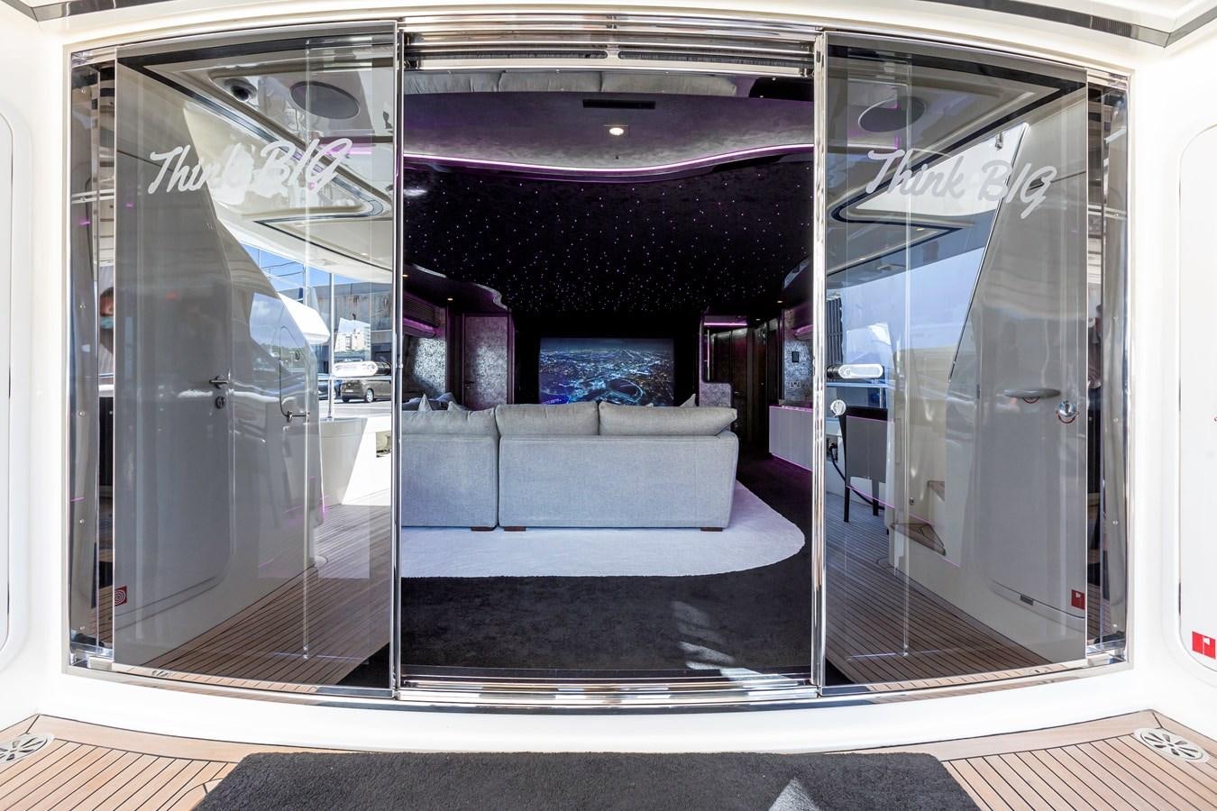 a glass door with a bench aboard THINK BIG Yacht for Sale