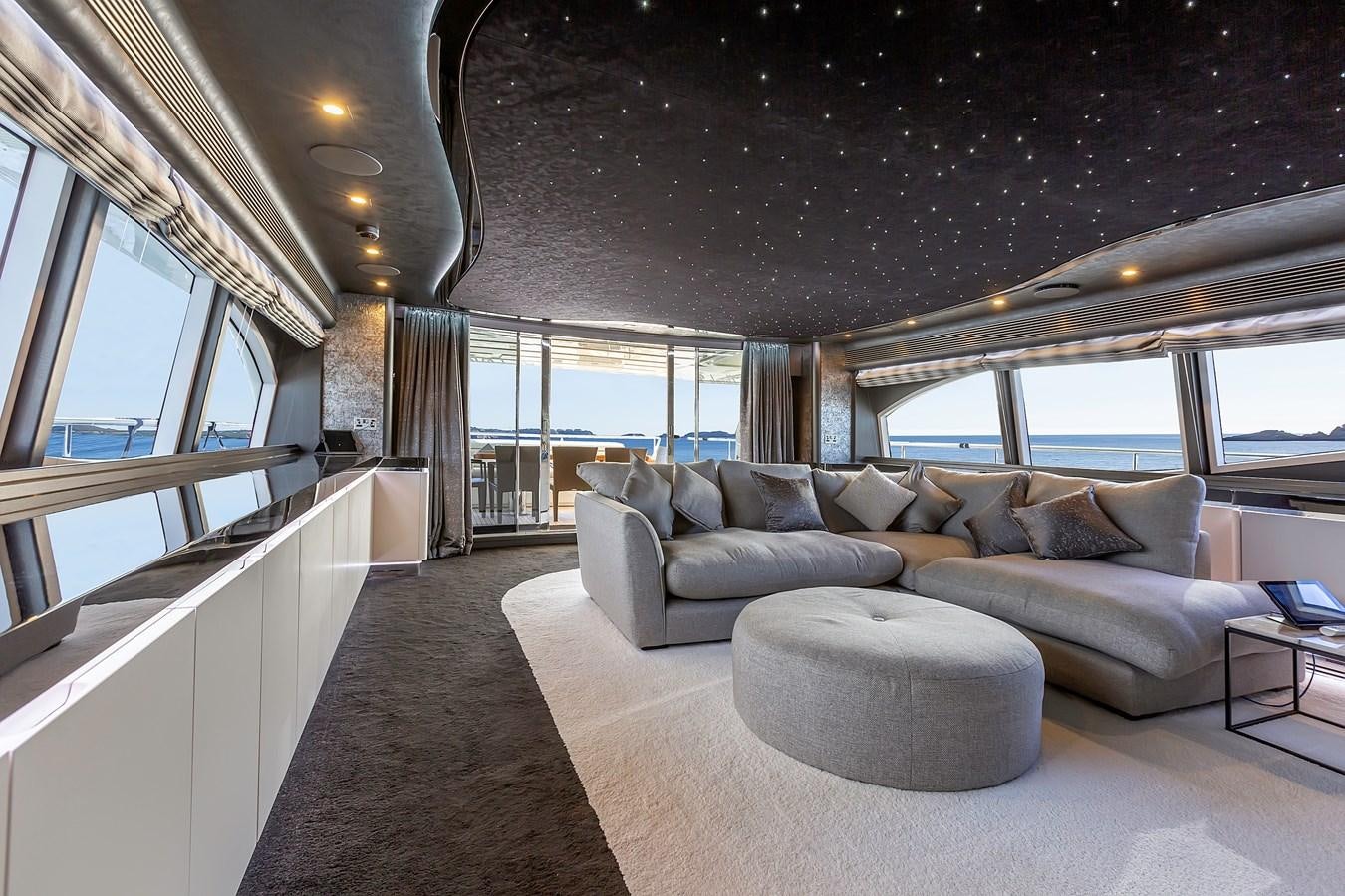 a living room with a large window aboard THINK BIG Yacht for Sale