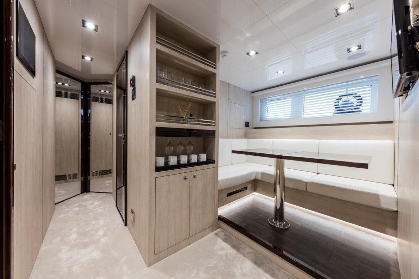 a room with a table and a window aboard PEARL Yacht for Sale