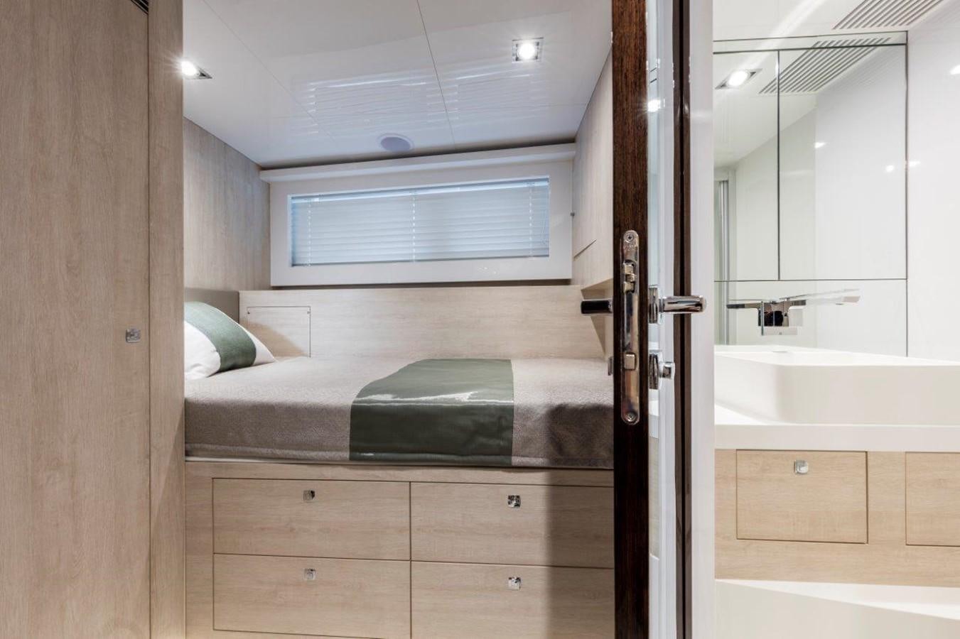 a bedroom with a bed and a sink aboard PEARL Yacht for Sale