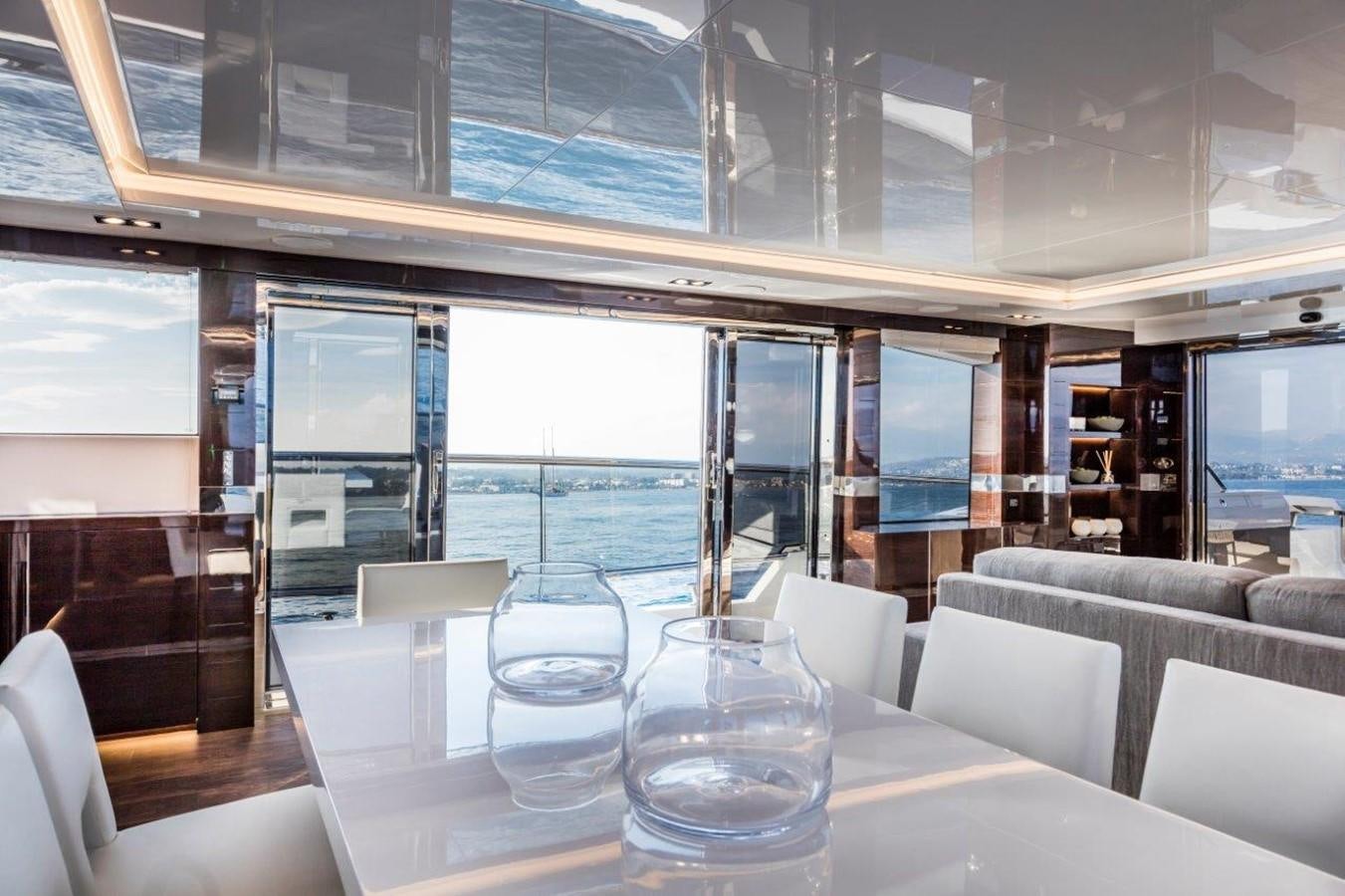 a room with tables and chairs aboard PEARL Yacht for Sale