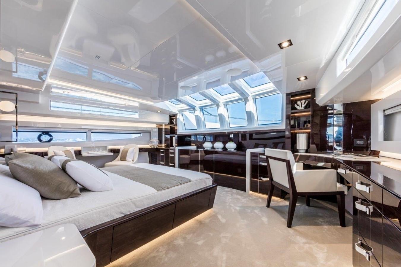 a room with a bed and a desk aboard PEARL Yacht for Sale