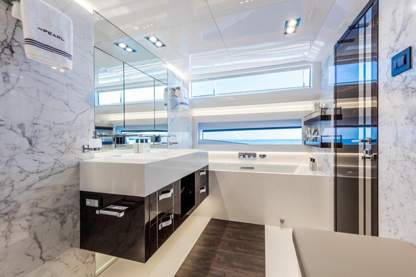 a kitchen with a countertop sink and cabinets aboard PEARL Yacht for Sale