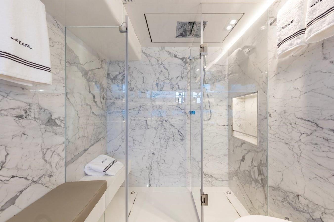 a bathroom with a glass shower aboard PEARL Yacht for Sale
