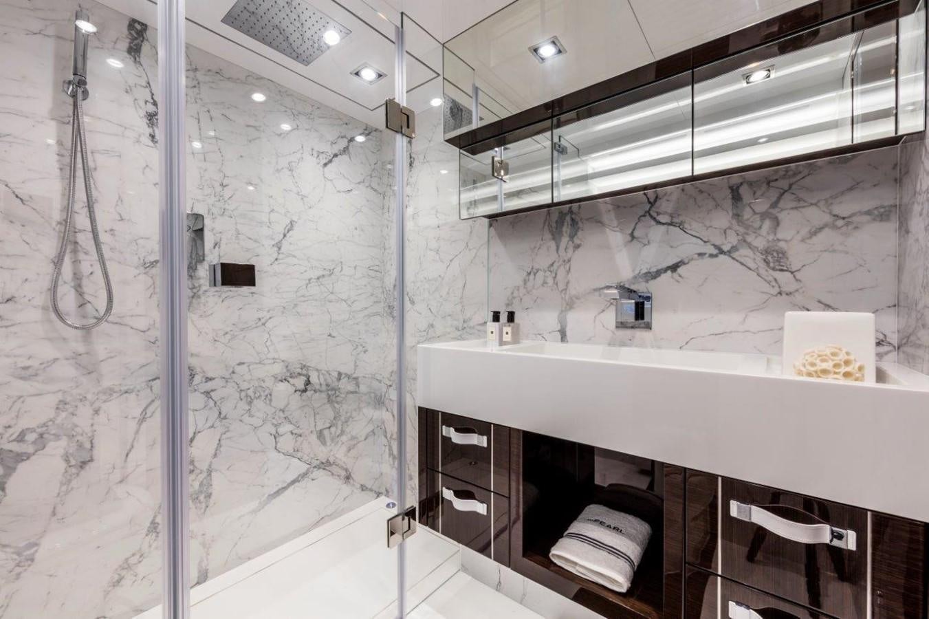 a bathroom with a glass wall aboard PEARL Yacht for Sale
