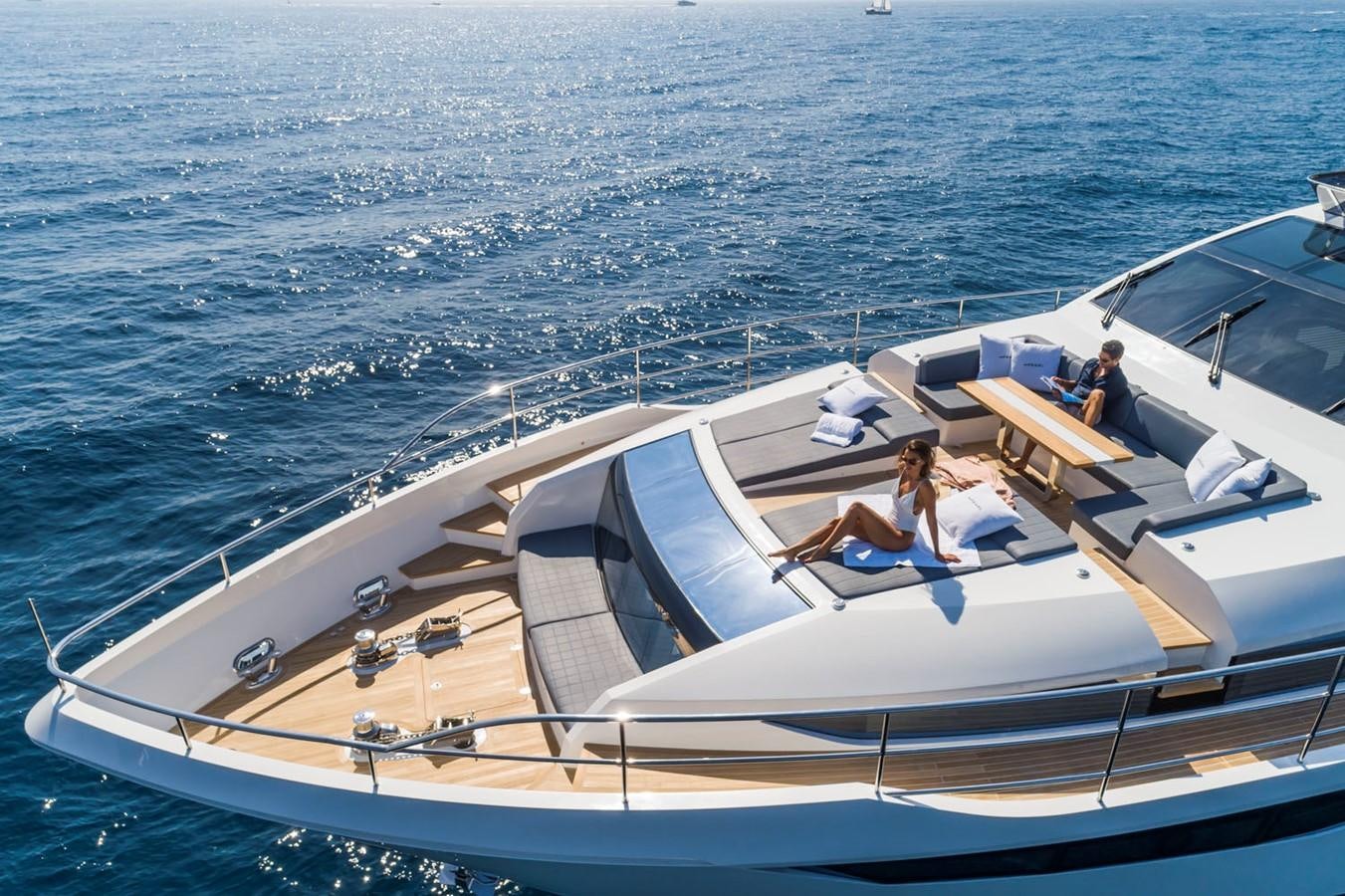 a man and woman sitting on a boat in the ocean aboard PEARL Yacht for Sale