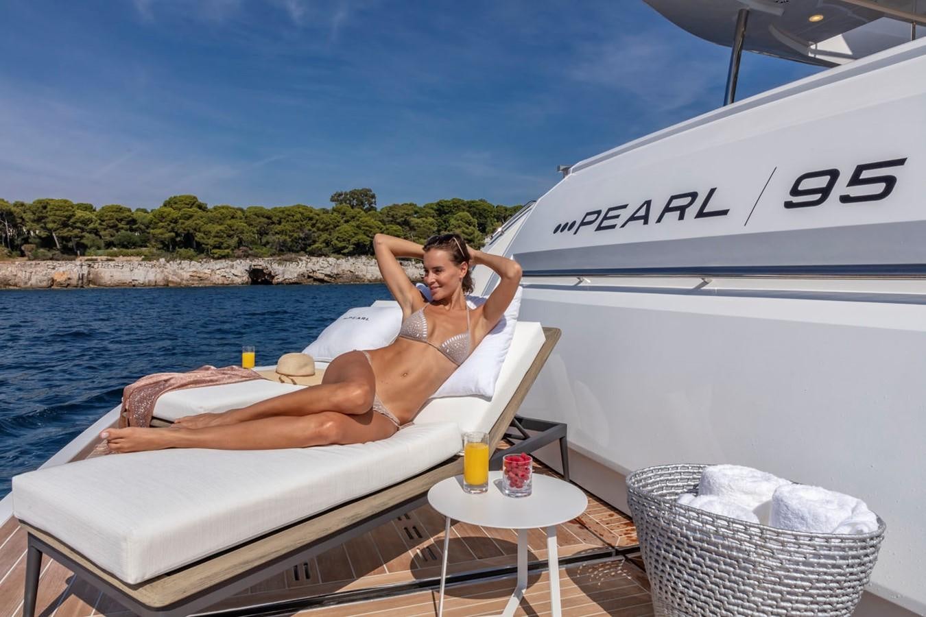 a person sitting in a chair on a boat aboard PEARL Yacht for Sale