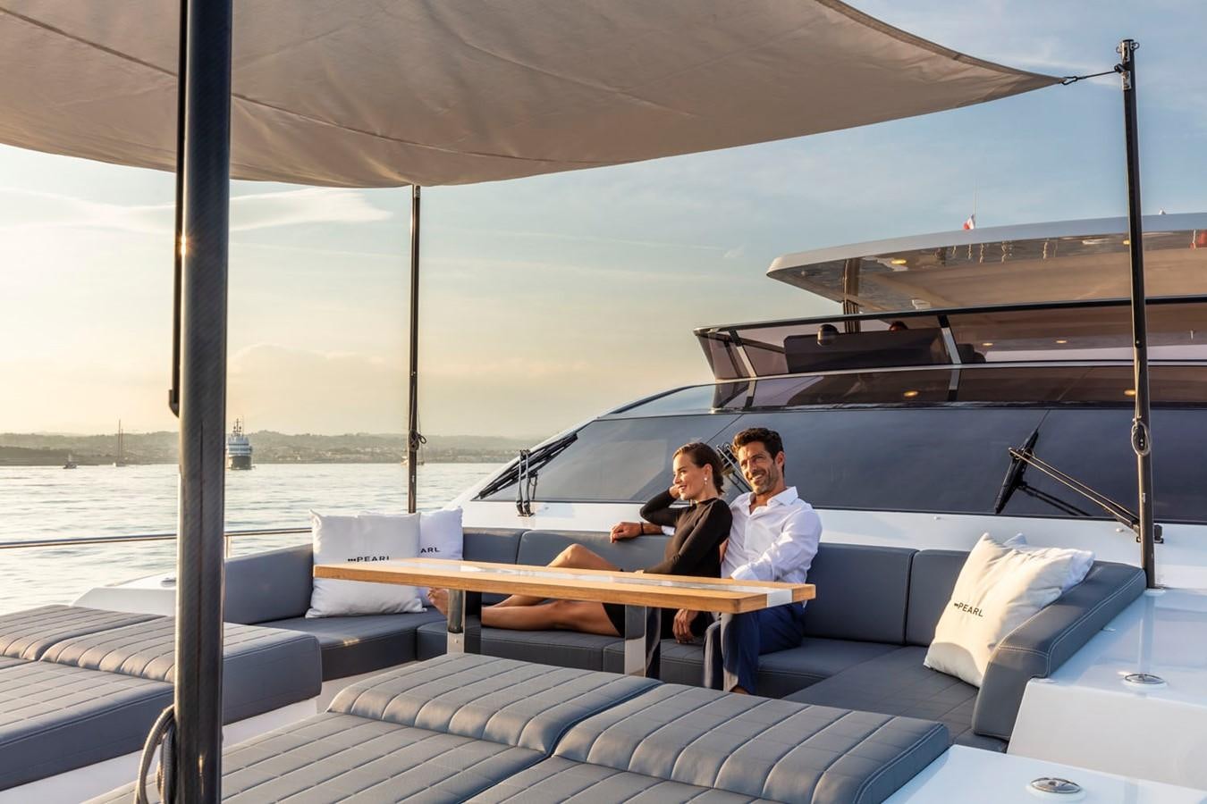 a couple sitting on a boat aboard PEARL Yacht for Sale