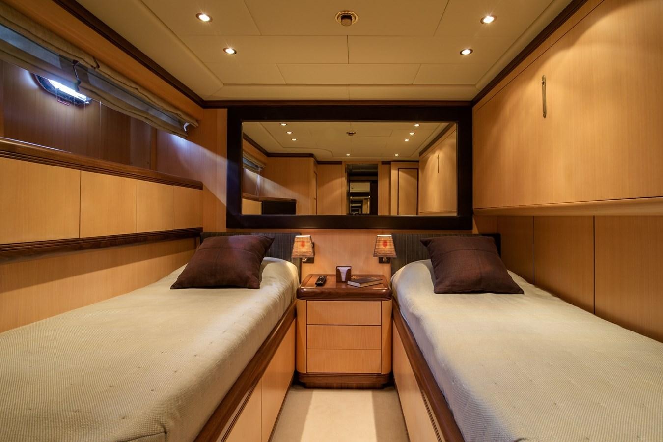 a room with beds and a mirror aboard LITTLE ZOE Yacht for Sale
