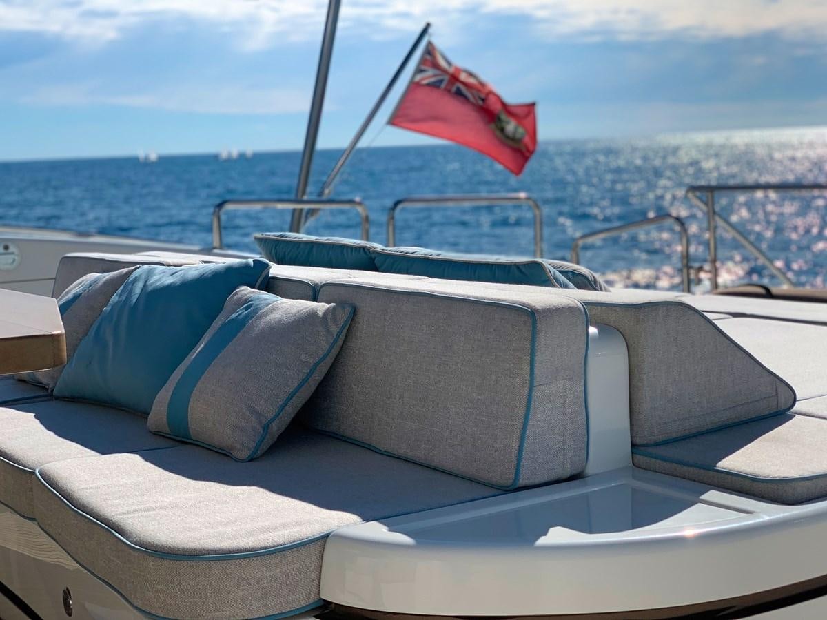 a boat with a flag on the front aboard LITTLE ZOE Yacht for Sale