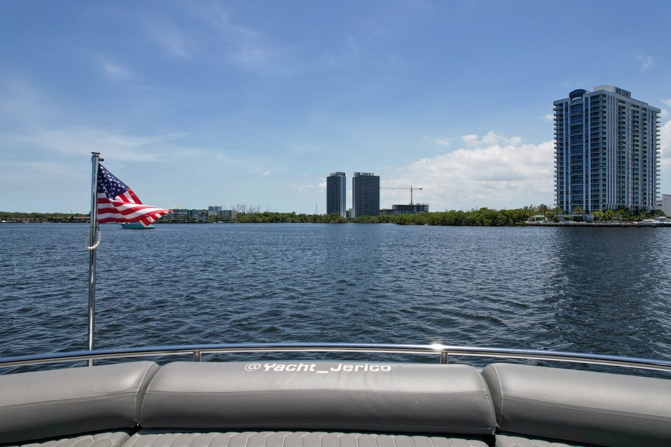 a boat on the water with a flag on it aboard SHADOW Yacht for Sale