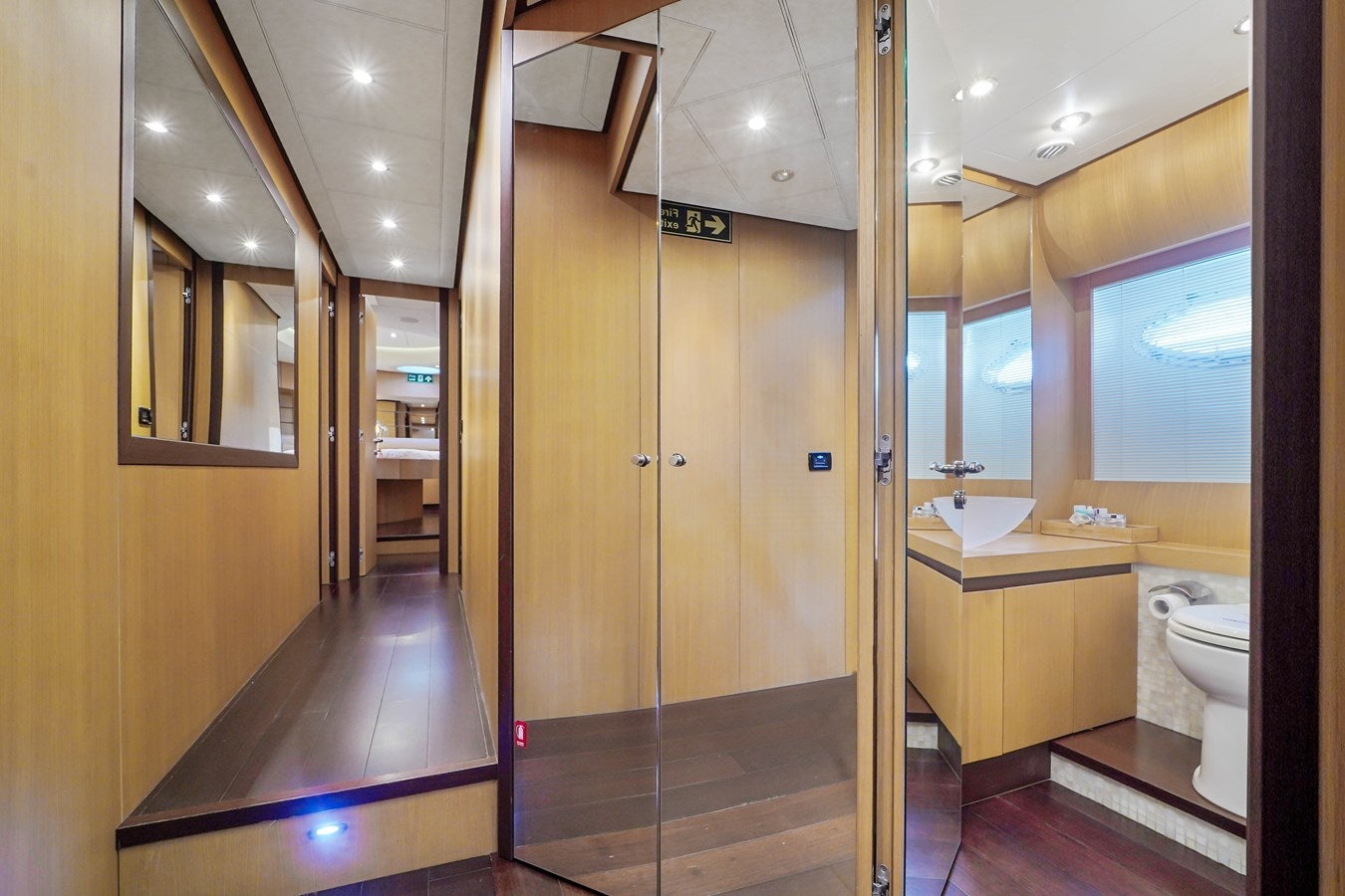 a bathroom with a shower unit and sinks aboard SHADOW Yacht for Sale