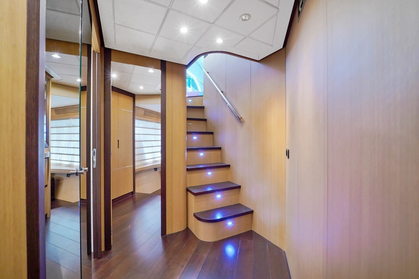 a room with a wood floor and a staircase aboard SHADOW Yacht for Sale