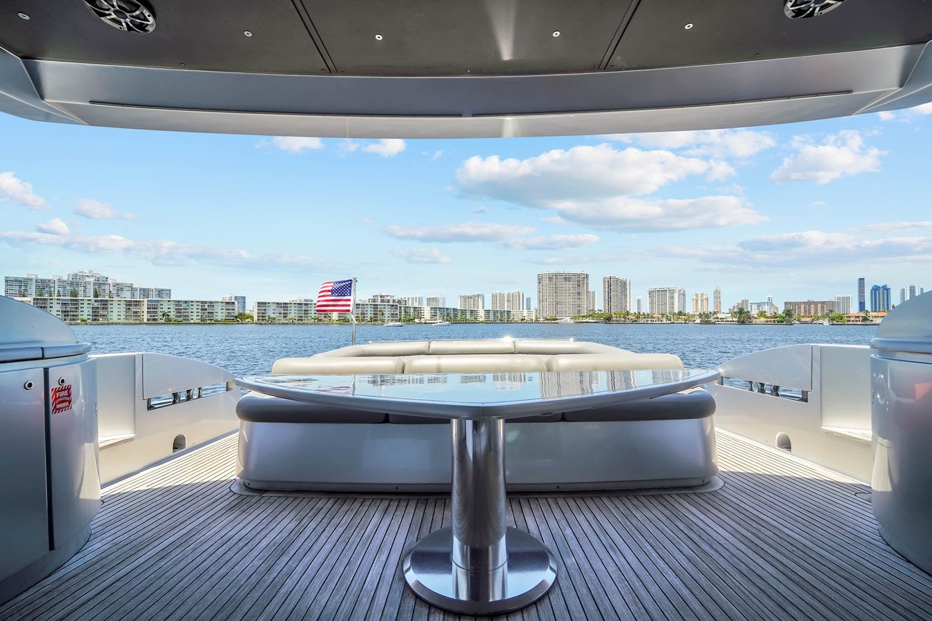 a table on a deck overlooking a city aboard SHADOW Yacht for Sale