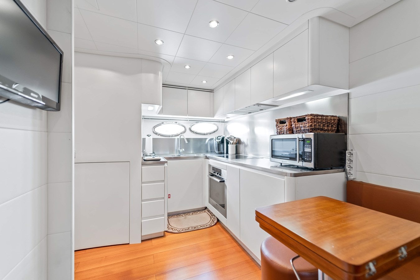 a kitchen with white cabinets aboard SHADOW Yacht for Sale