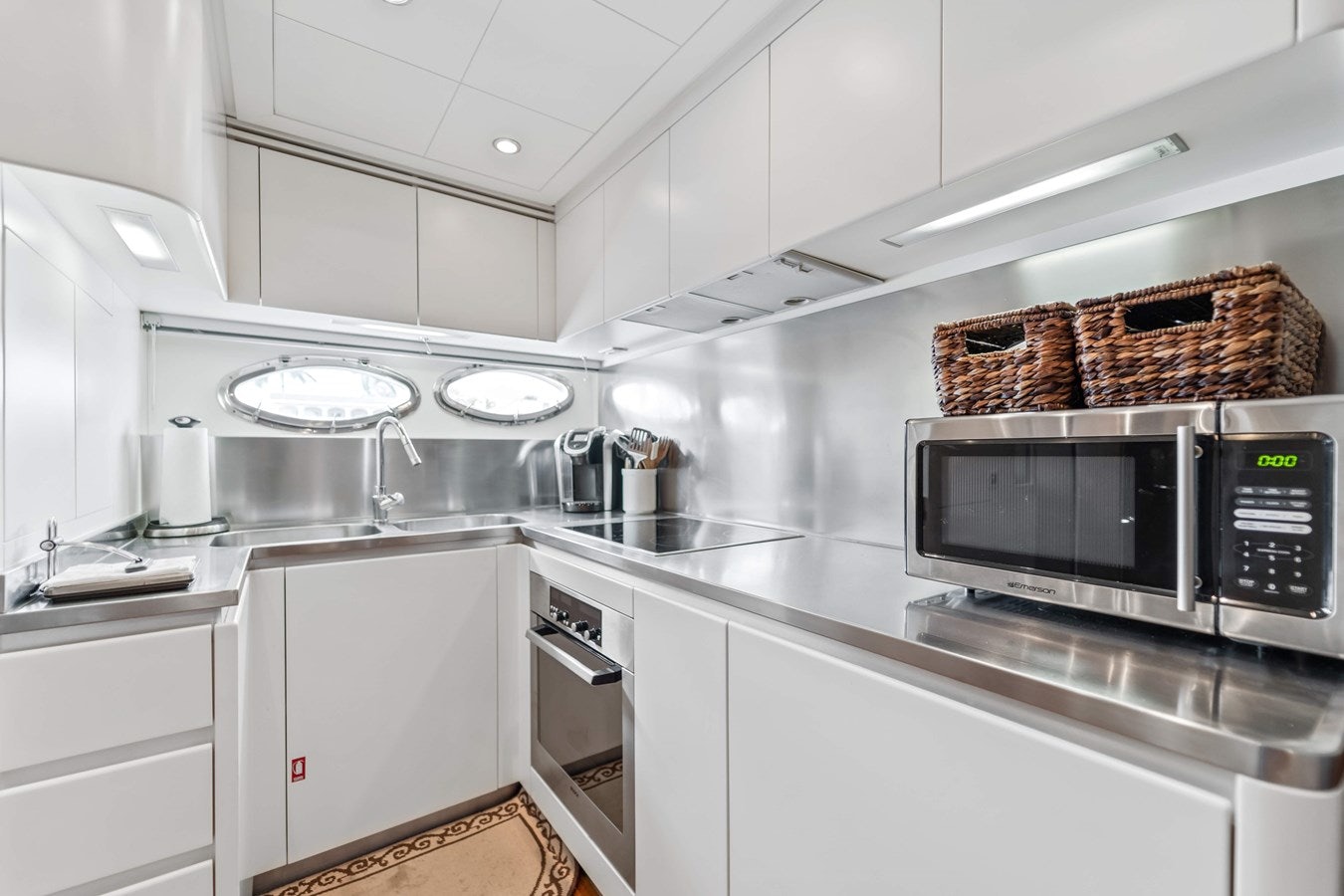 a kitchen with white cabinets aboard SHADOW Yacht for Sale