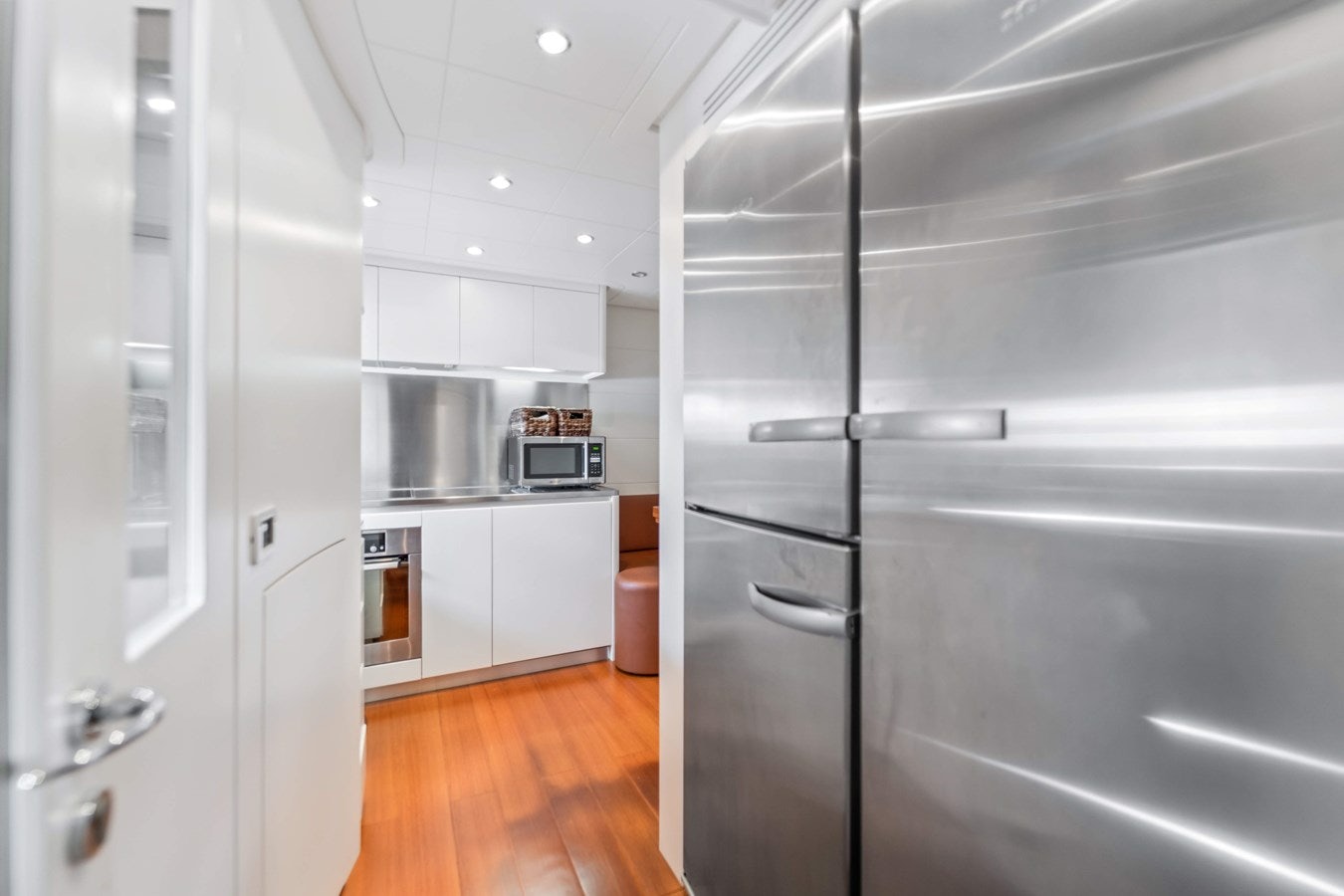 a kitchen with white cabinets aboard SHADOW Yacht for Sale