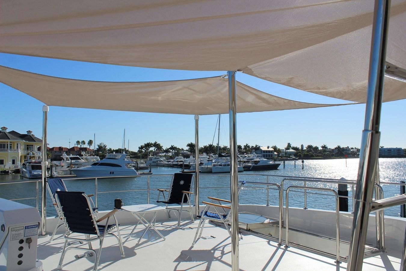 a deck with chairs and umbrellas aboard ONE SHOT Yacht for Sale