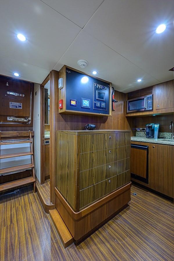 a kitchen with wooden cabinets aboard ONE SHOT Yacht for Sale